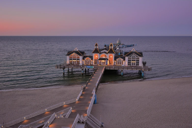 a pier sitting on top of a sandy beach next to the ocean, a digital rendering, by Juergen von Huendeberg, pexels contest winner, evening lights, square, gigapixel maximum upscale, hut