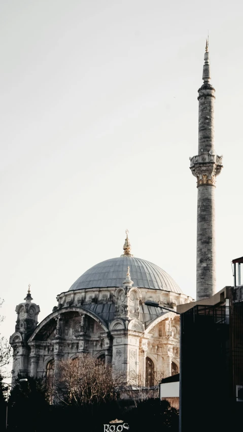 a large building sitting next to a tall building, by Ismail Acar, pexels contest winner, hurufiyya, neoclassical tower with dome, profile image, ottoman sultanate, 256x256