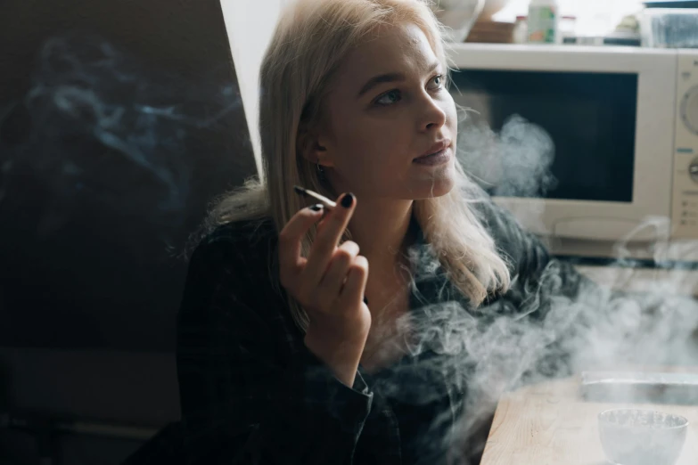 a woman smokes a cigarette in front of a microwave, inspired by Elsa Bleda, pexels contest winner, renaissance, close up of a blonde woman, marijuana smoke, sitting in her room, satisfied pose