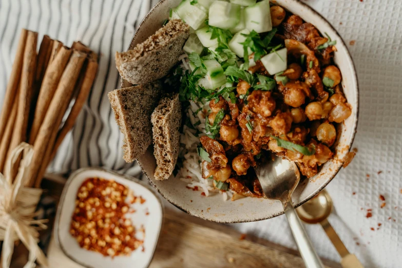 a bowl of food sitting on top of a table, by Emma Andijewska, pexels contest winner, spicy, polka dot, boho, rich details full of texture