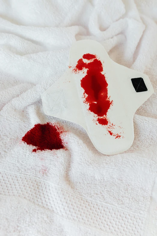 a blood spatula on a white towel on a bed, by Ellen Gallagher, hurufiyya, silicone patch design, shootout, blood drenched, from the waist up