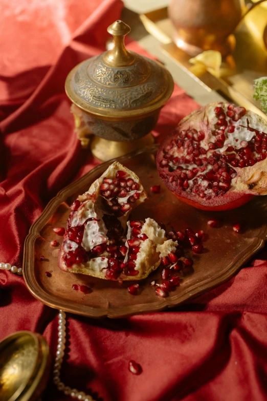 a close up of a plate of food on a table, inspired by Osman Hamdi Bey, arabesque, pomegranate, sparkling, movie still, battered