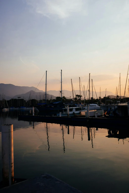 a number of boats in a body of water, by Dave Melvin, the city of santa barbara, filtered evening light, 8 k -, reflection