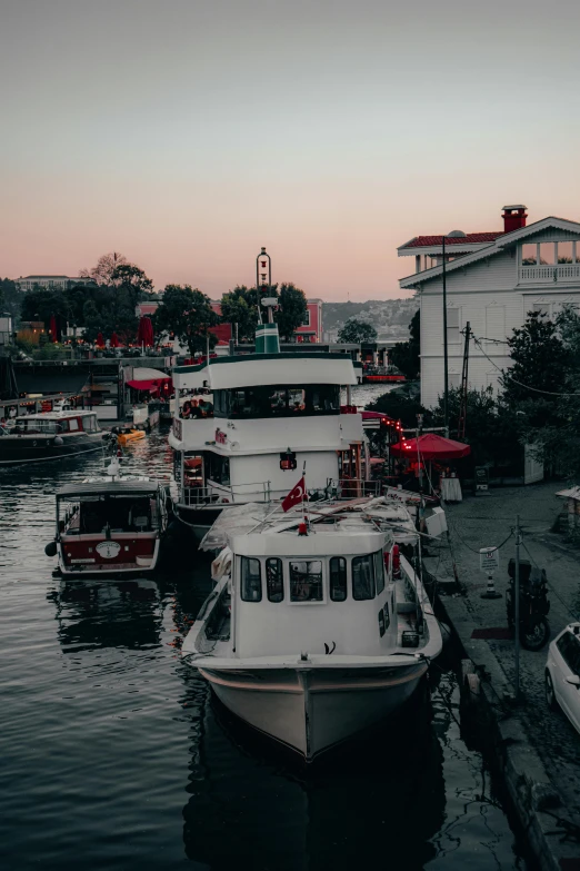 a number of boats in a body of water, by Niko Henrichon, pexels contest winner, fallout style istanbul, thumbnail, moored, early evening