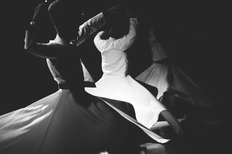 a couple of people that are dancing in the dark, a black and white photo, arabesque, wearing white robes, instagram photo, islamic, 15081959 21121991 01012000 4k