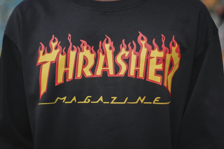 a man wearing a black thrash magazine sweatshirt, wildfire, details, close medium shot, braziers