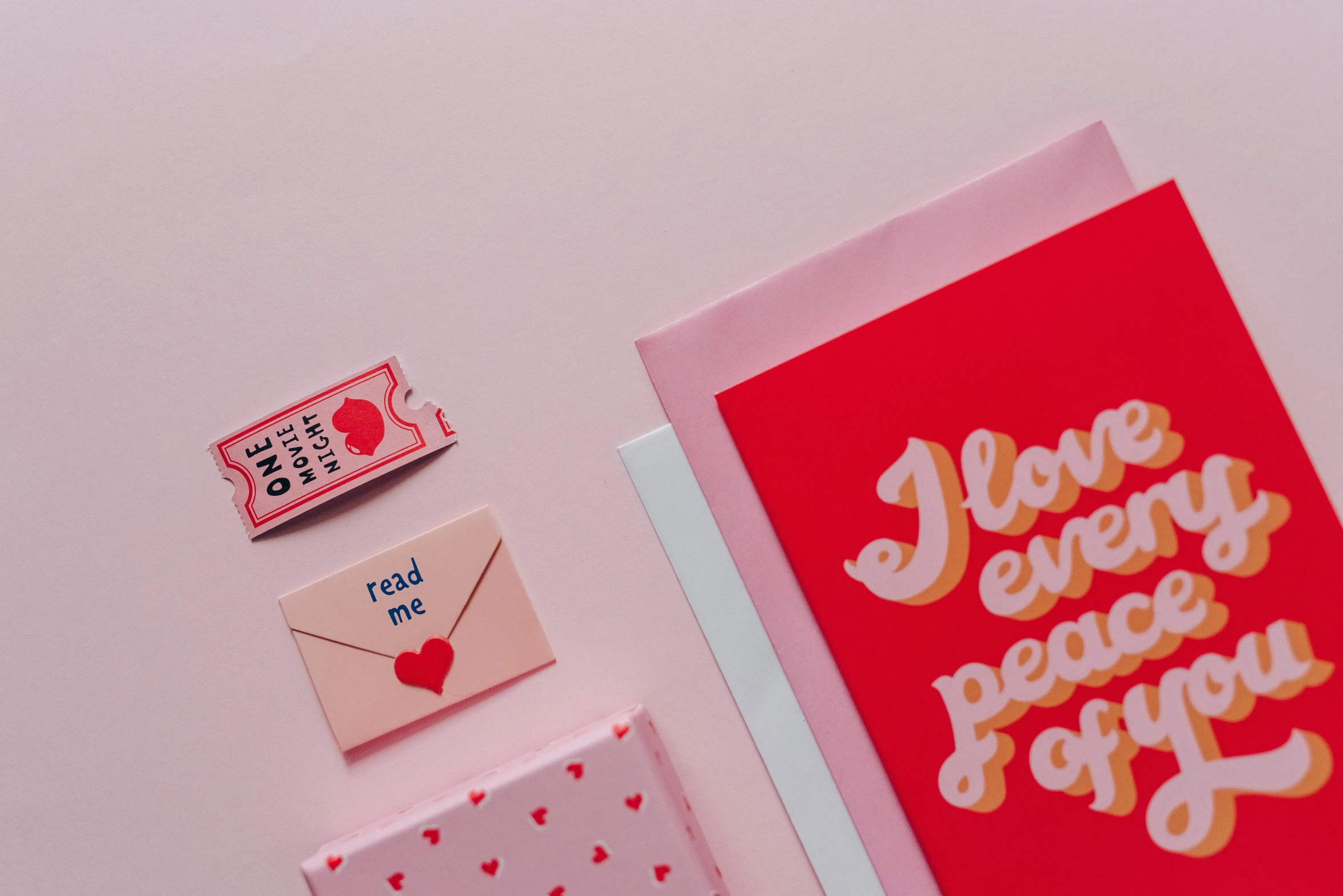 valentine's day greetings laid out on a table, trending on pexels, mail art, style of wes anderson, red colour palette, minimal pink palette, brand identity