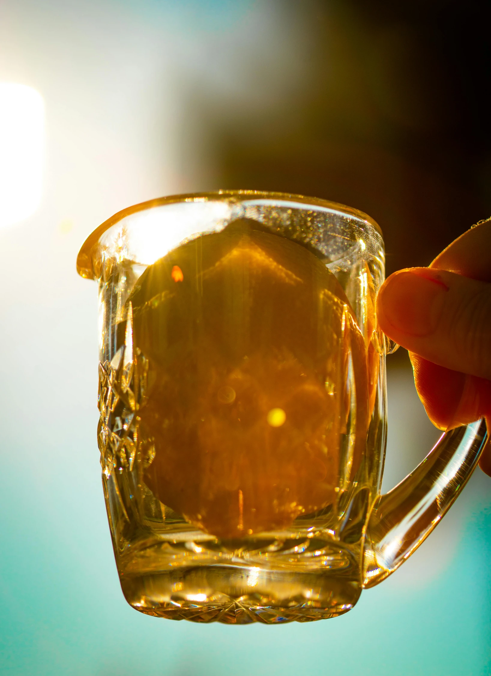 a close up of a person holding a glass of beer, by Adam Marczyński, golden hour”, “ golden cup, slide show, glass jar