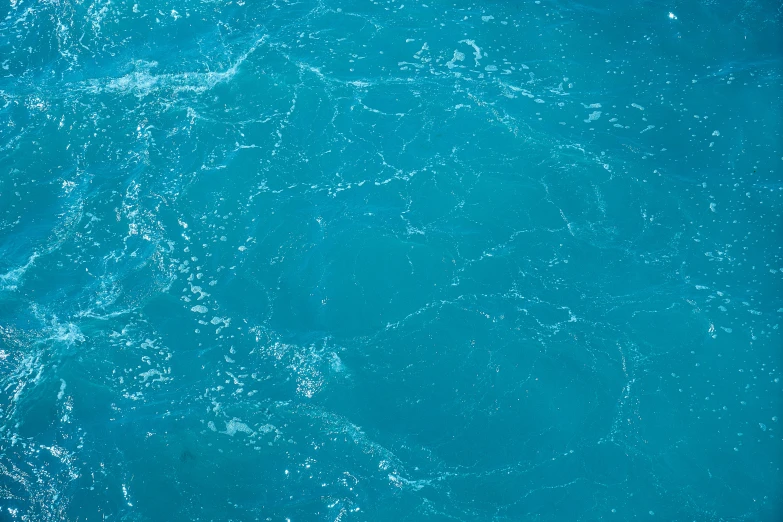 a man riding a wave on top of a surfboard, an album cover, by Elsa Bleda, hurufiyya, blue veins, close-up from above, teal, made of water