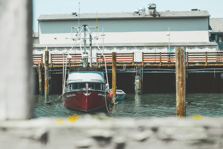 a red and white boat in a body of water, a portrait, by Carey Morris, pexels contest winner, docked at harbor, ballard, vsco film grain, fishing