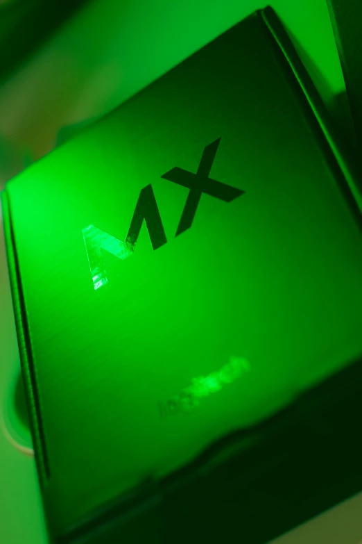a green box sitting on top of a table, graffiti, green lights, x logo, mx2, high angle close up shot