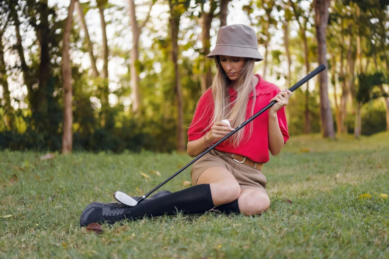 a woman sitting on the ground holding a golf club, unsplash, realism, wearing kneesocks, avatar image, outdoors, bashful expression