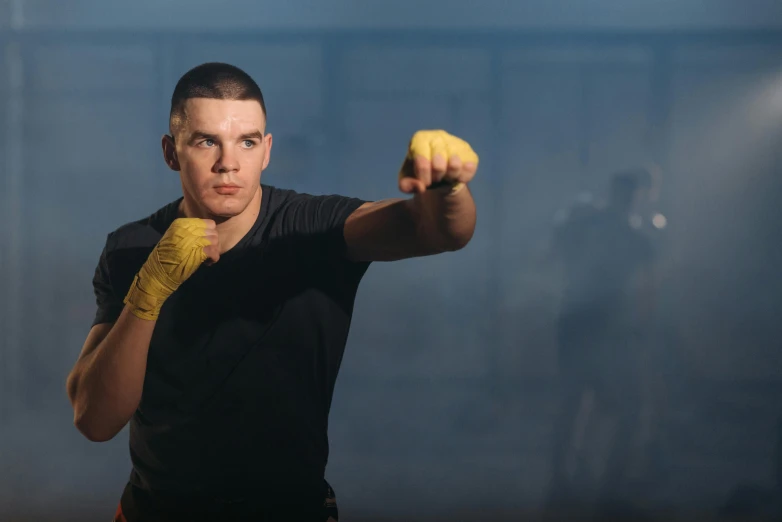 a man in a black shirt and yellow gloves, a portrait, inspired by Carlos Berlanga, shutterstock, ultimate fighting championship, person in foreground, julian ope, avatar image