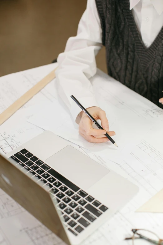 a person sitting at a table with a laptop and a pen, architectural planning, centered design, promo image, rectangle