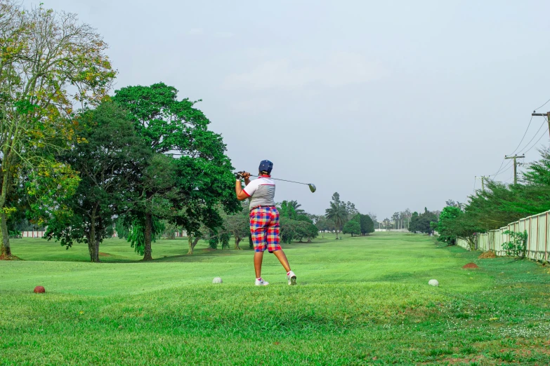 a man swinging a golf club at a golf course, inspired by Shirley Teed, pexels contest winner, sri lanka, avatar image, thumbnail