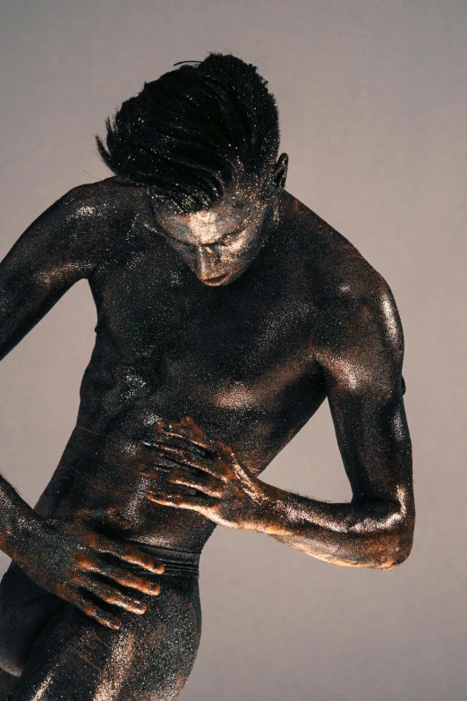 a statue of a man covered in mud, a bronze sculpture, inspired by Herb Ritts, iridescent skin, passionate pose, steel gray body, thin young male