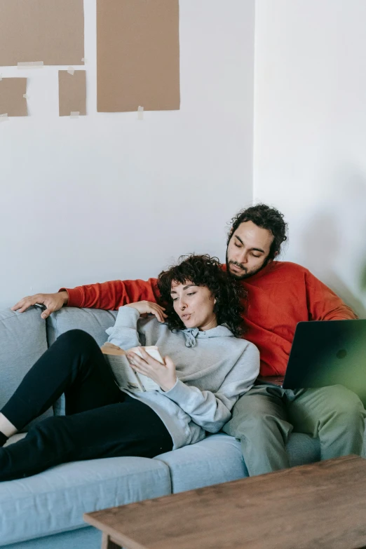 a man and a woman sitting on a couch, pexels contest winner, connectivity, reddit post, curled up on a book, developers