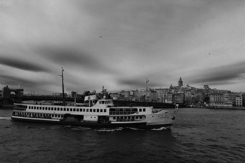 a black and white photo of a boat in the water, a black and white photo, by Niyazi Selimoglu, pexels contest winner, city view, overcast!!!, mixed art, surikov