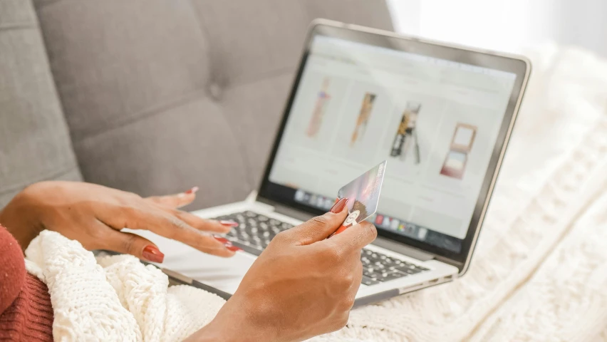 a woman sitting on a couch using a laptop computer, trending on pexels, holding ace card, essence, outfit photograph, inspect in inventory image