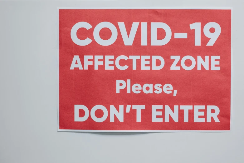 a red sign that says covidid - 19 affected zone please don't enter, a poster, by John Covert, pexels, dezeen, print, actual photo, image