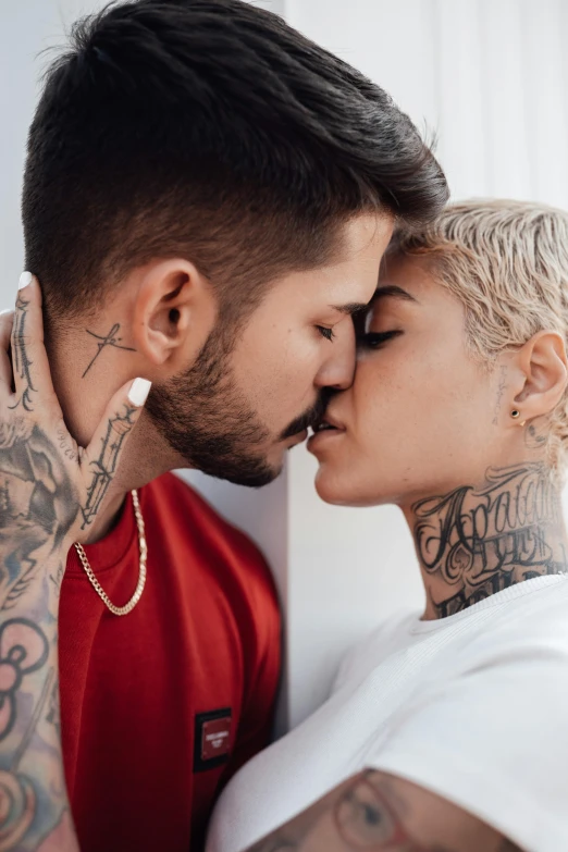 a man kissing a woman with tattoos on his arms, trending on pexels, zayn malik, androgynous face, killian eng, brazil