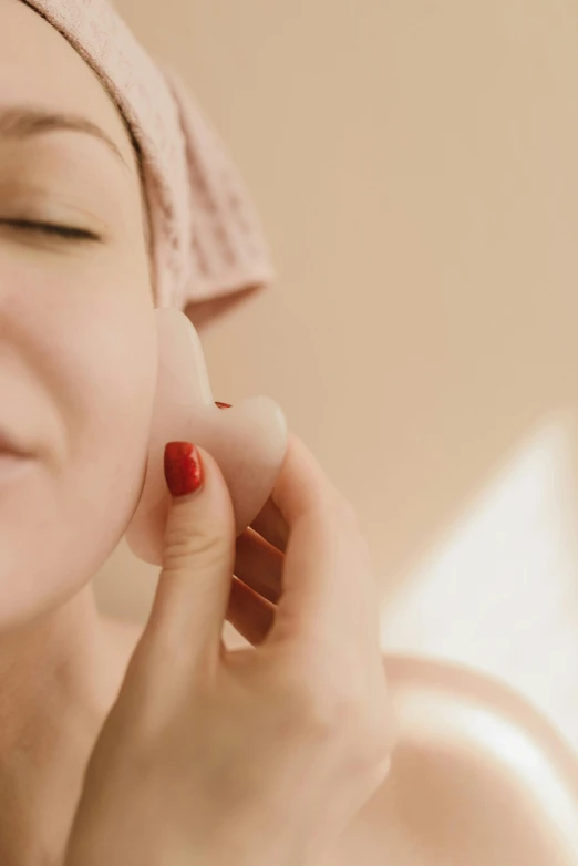 a woman with a towel on her head brushing her teeth, by Julia Pishtar, trending on pexels, renaissance, wearing pearl earrings, soft red lights, synthetic bio skin, square facial structure