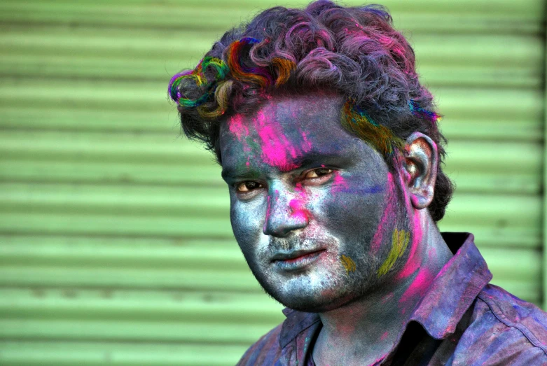 a man with paint all over his face, a colorized photo, vinayak, hair coloring, rainbow sheen, fan favorite