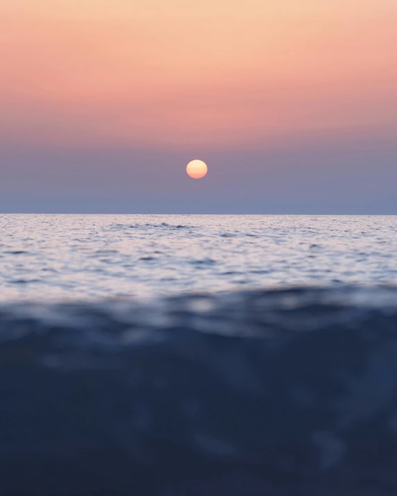 the sun is setting on the horizon of the ocean, pexels contest winner, romanticism, on the surface of the ocean, grey, circle, photo for magazine