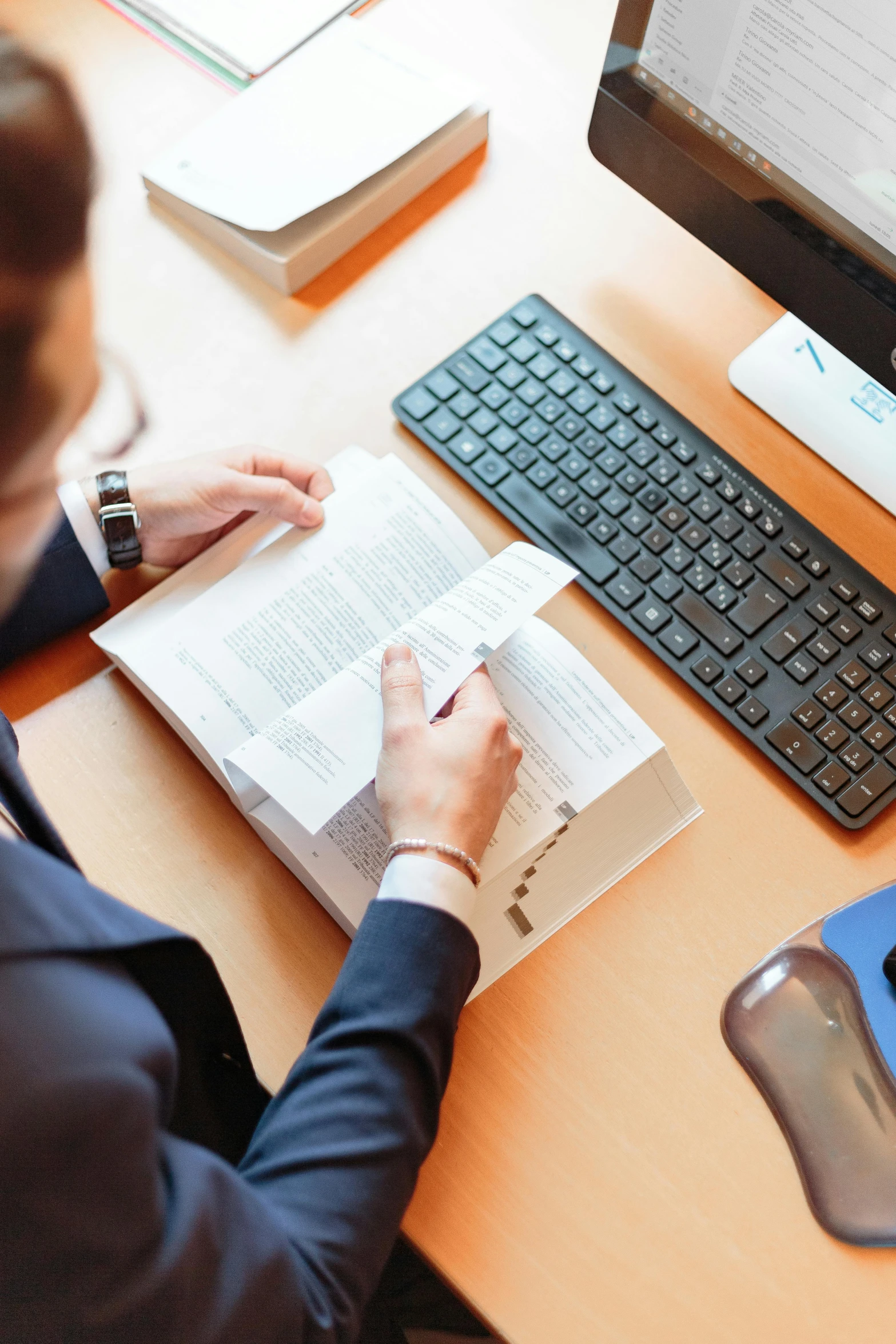 a woman sitting at a desk in front of a computer, by Carey Morris, trending on reddit, private press, a high angle shot, lawyer, selling insurance, person in foreground