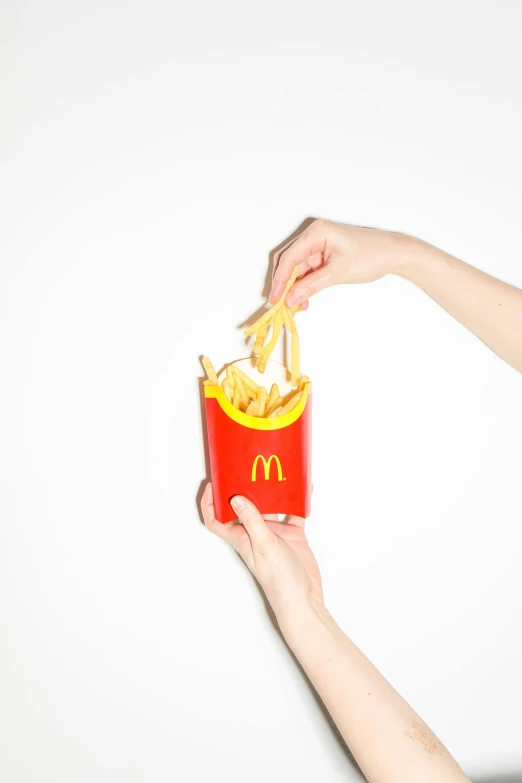 a person holding a box of french fries, unsplash, photorealism, clemens ascher, mcdonalds restaurant, ilustration, medium