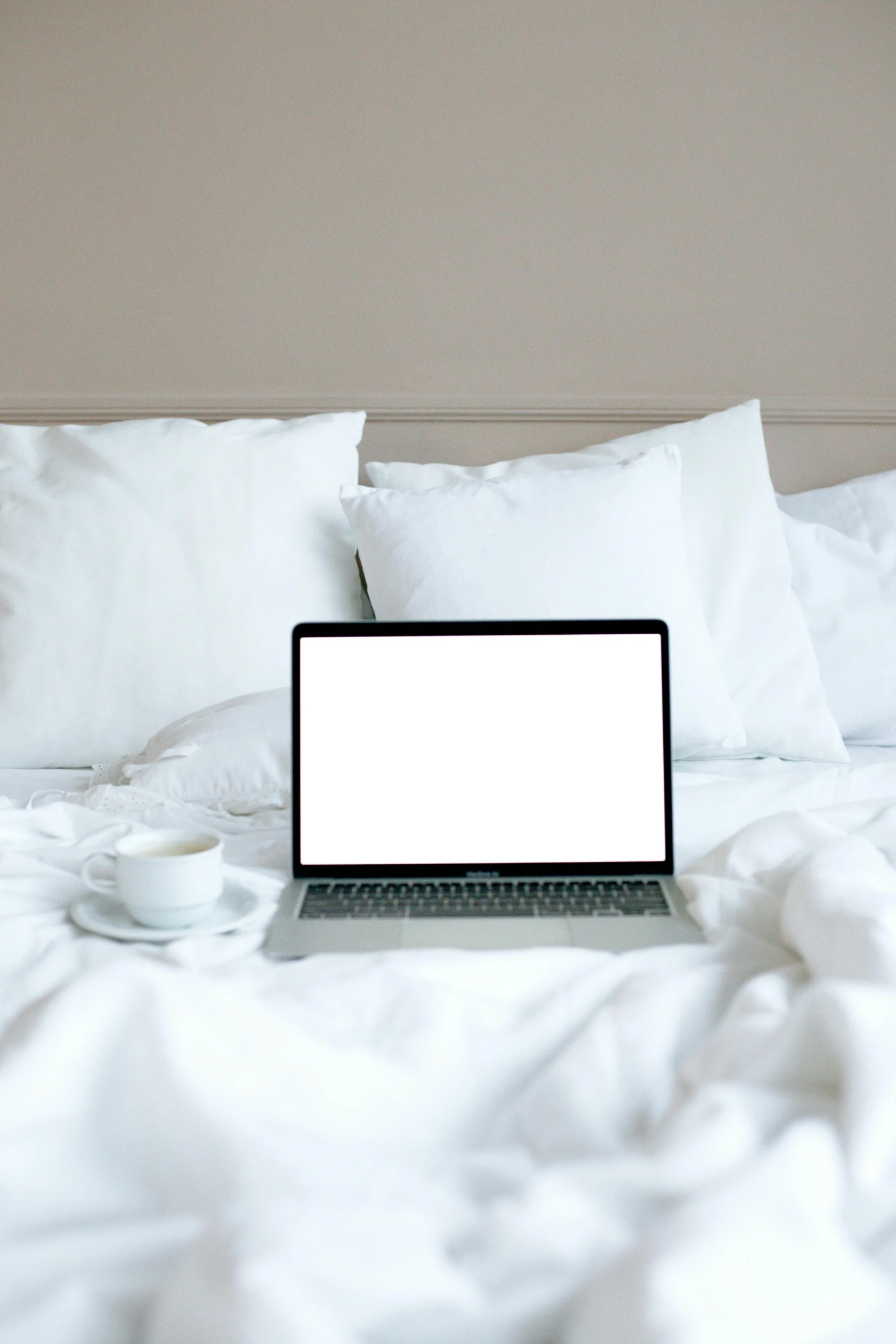 a laptop computer sitting on top of a bed, by Carey Morris, pexels, white pillows, rectangle, multiple stories, on a white table