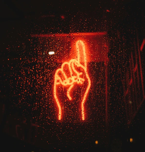 a neon sign that is on the side of a building, inspired by Elsa Bleda, pexels, graffiti, raised fist, rain aesthetic, red power, thumb up