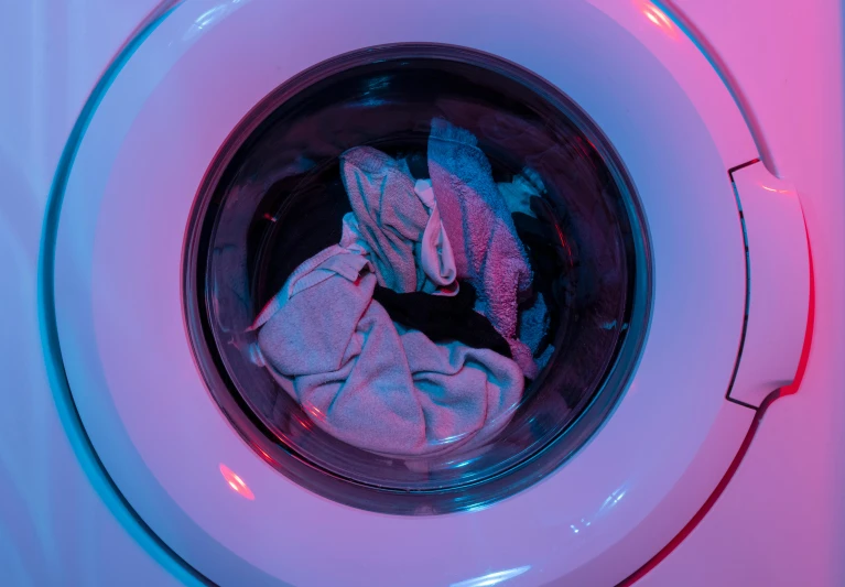 a close up of a washing machine with clothes in it, pexels contest winner, pink and blue lighting, 15081959 21121991 01012000 4k, ariel perez, cmyk