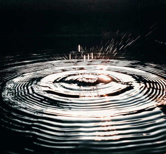 a water drop in the middle of a body of water, a stipple, trending on unsplash, spinning whirlwind, light circles, in a lake, low-light