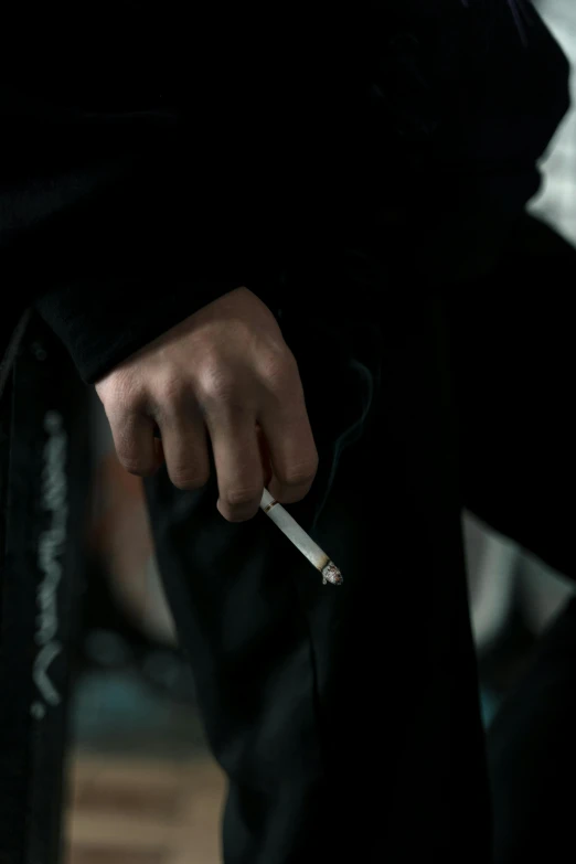 a close up of a person holding a cigarette, black habit, large)}], drugs, pose 4 of 1 6