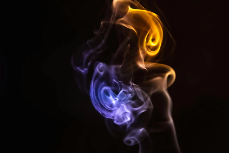 a close up of smoke on a black background, by Jan Rustem, unsplash, art photography, purple and yellow lighting, angel is split in two with smoke, blue and white and red mist, small fire