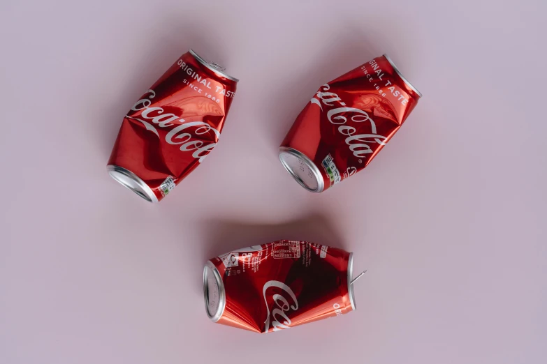 a group of soda cans sitting on top of a table, by Yanjun Cheng, trending on unsplash, hyperrealism, red realistic 3 d render, crushed, high quality product image”, morning. hyperrealism