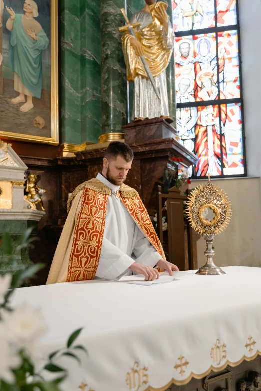 a priest sitting at a table in a church, by Matthias Stom, unsplash, ornamental halo, on the altar, a handsome, stanisław