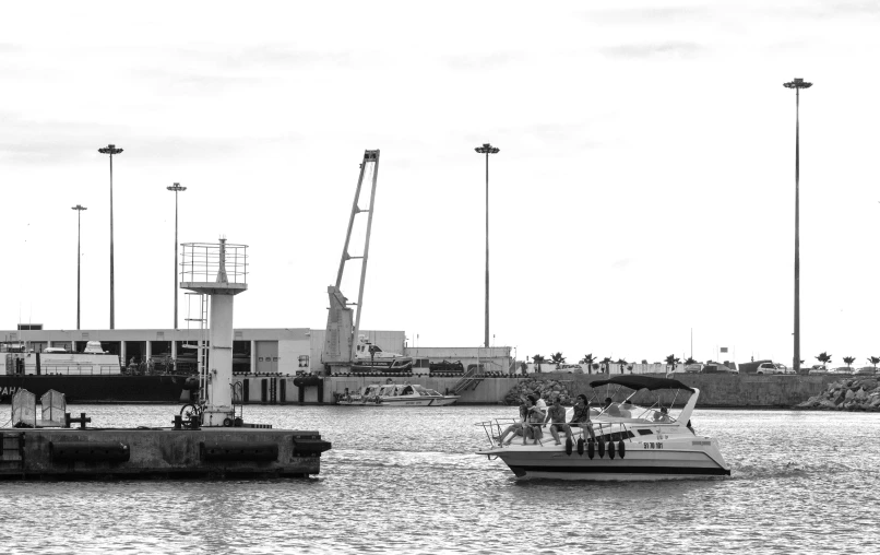 a couple of boats that are in the water, a black and white photo, by Felipe Seade, happening, terminal, everyone having fun, port scene background, people at work