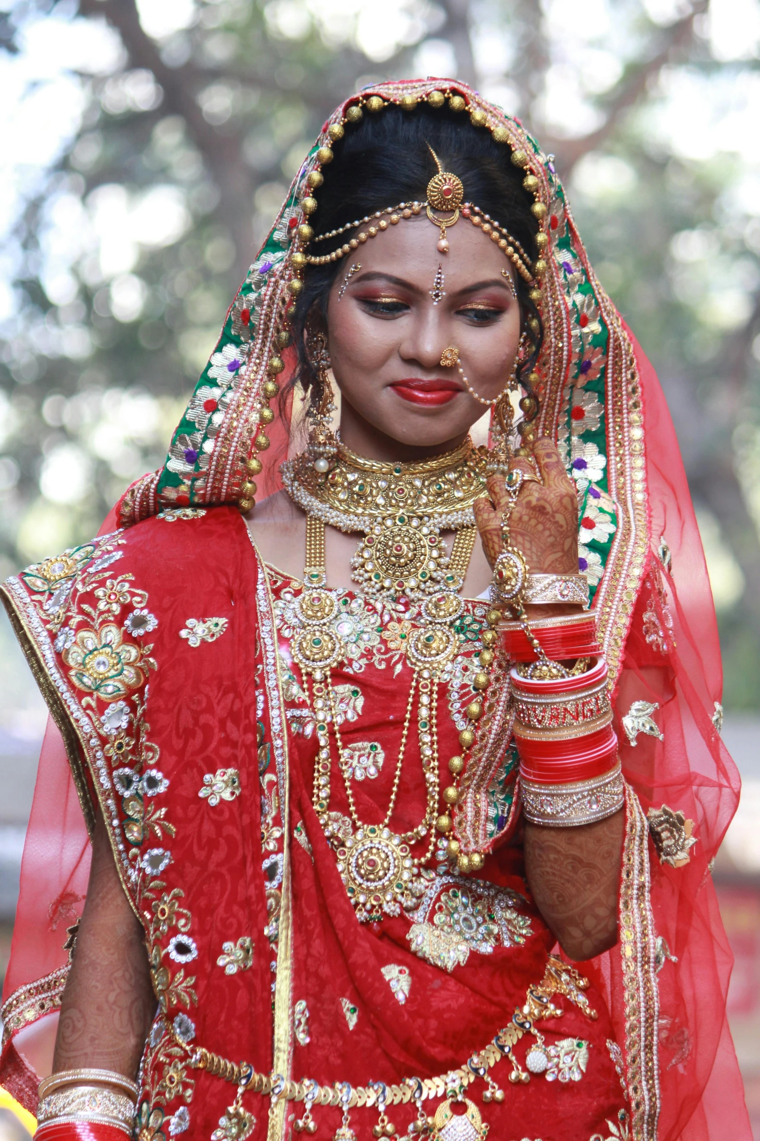 a woman dressed in a red and gold outfit, by Gwen Barnard, pexels, hurufiyya, wearing a wedding dress, indian girl with brown skin, 15081959 21121991 01012000 4k, jewelled