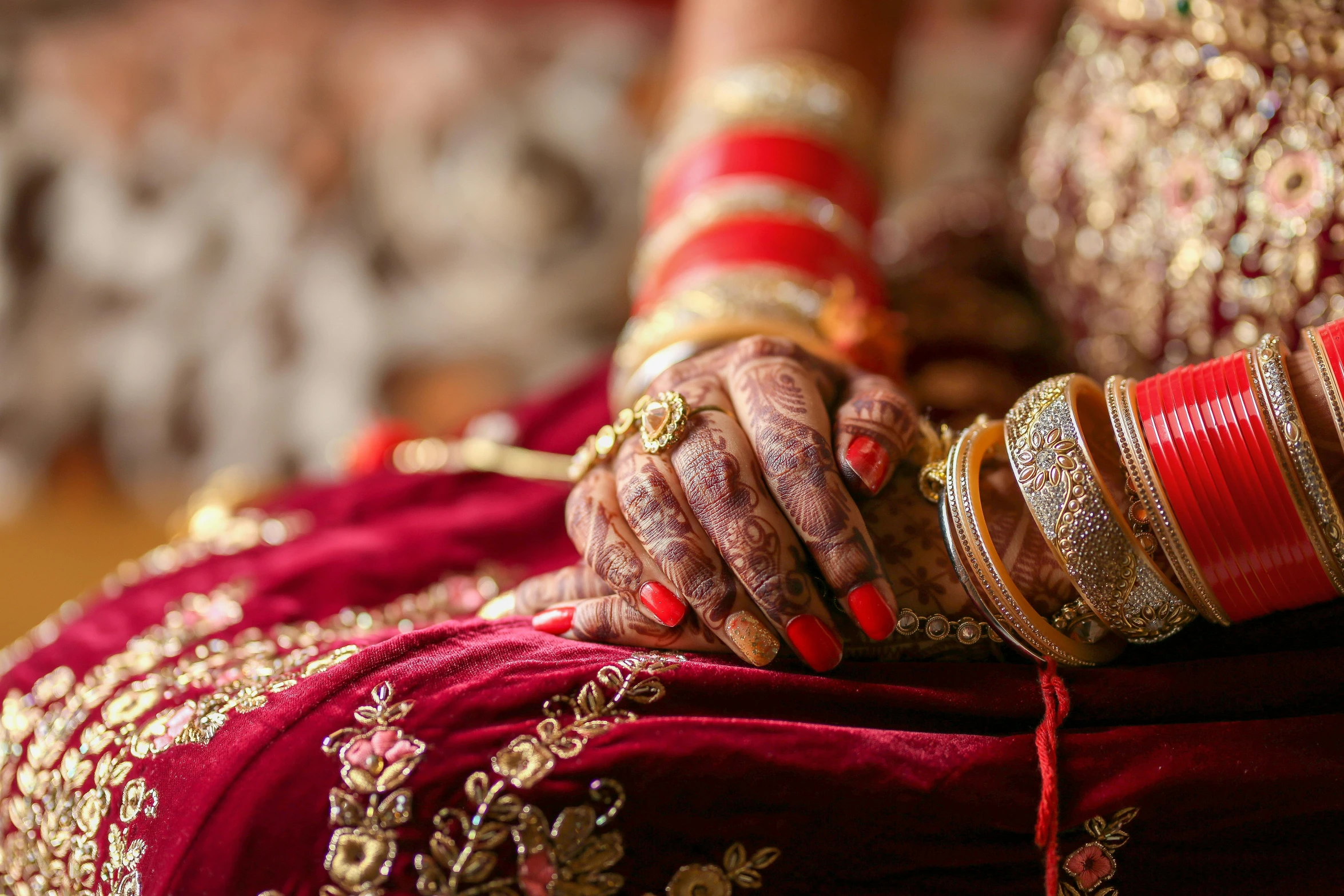 a close up of the hands of a bride, trending on unsplash, hurufiyya, red and gold cloth, thumbnail, bracelets, full length shot