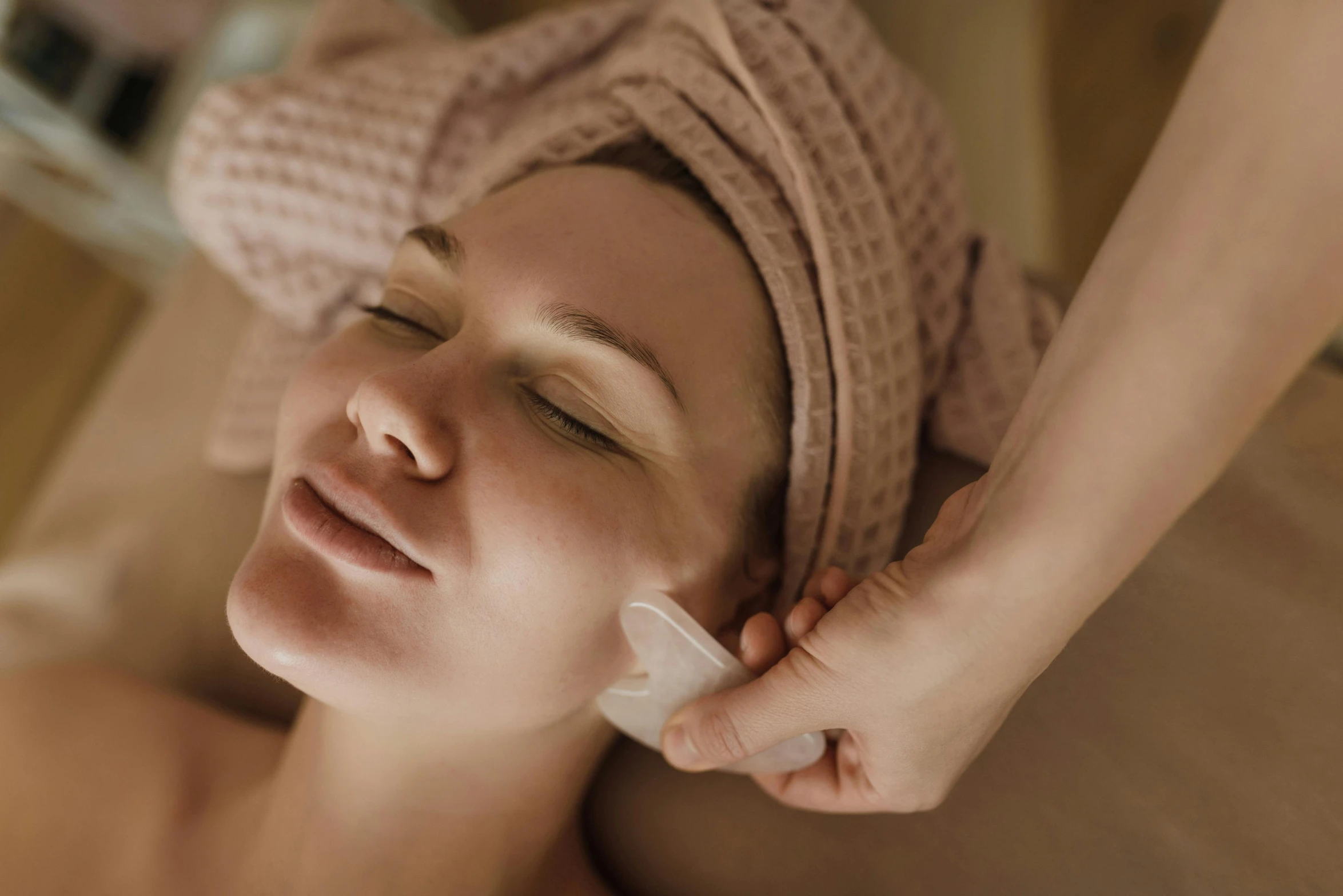 a woman getting a facial massage with a towel on her head, by Emma Andijewska, trending on pexels, renaissance, sepia toned, eucalyptus, smirking, realistic depth