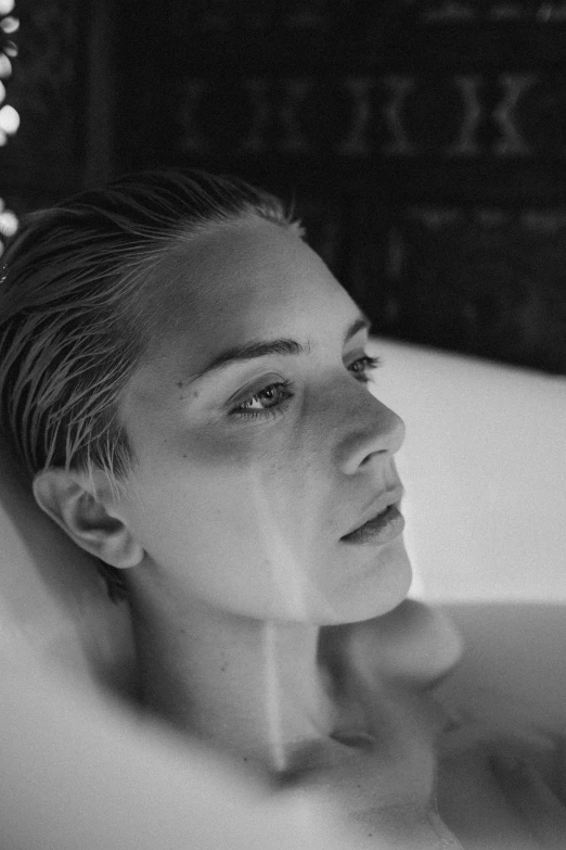 a black and white photo of a woman in a bathtub, inspired by Max Dupain, hyperrealism, kristanna loken, photoshoot for skincare brand, movie still of a tired, fall
