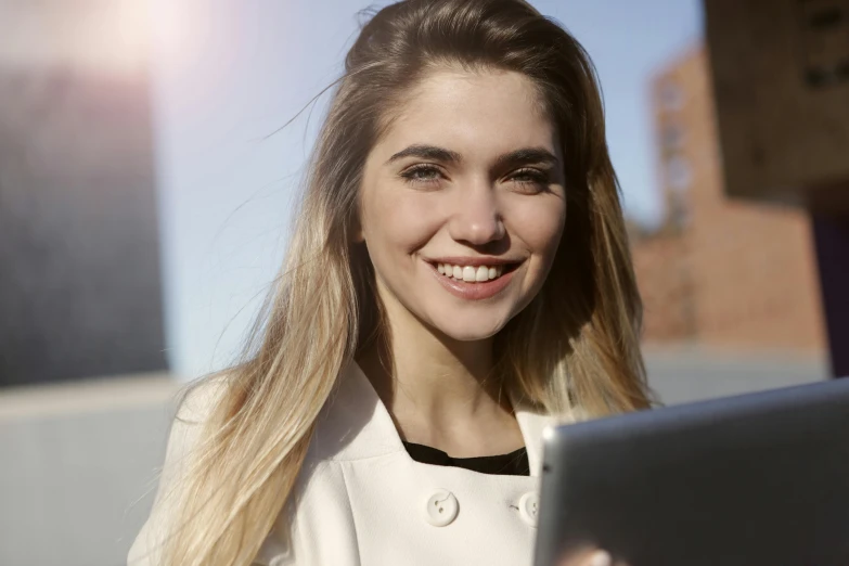 a beautiful young woman holding a tablet computer, a picture, by Niko Henrichon, trending on pexels, imogen poots, bottom angle, optimistic smile, professional image