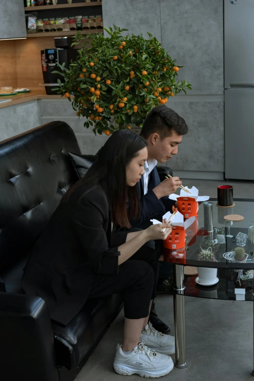 a couple of people that are sitting on a couch, by Reuben Tam, reddit, having a snack, in office, smoking, plating