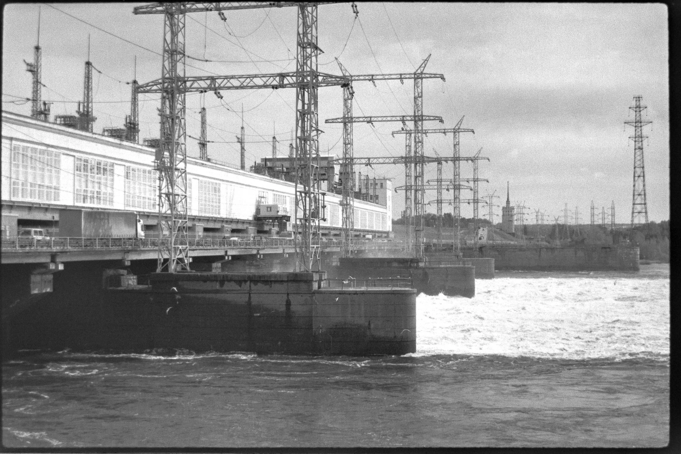 a black and white photo of a boat in the water, sōsaku hanga, reactor circuits, russia, film footage, cranes