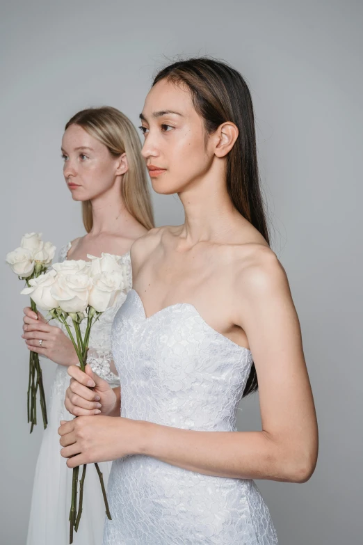 two women standing next to each other holding flowers, by Winona Nelson, in wedding dresses, beauty campaign, mai anh tran, straight neck