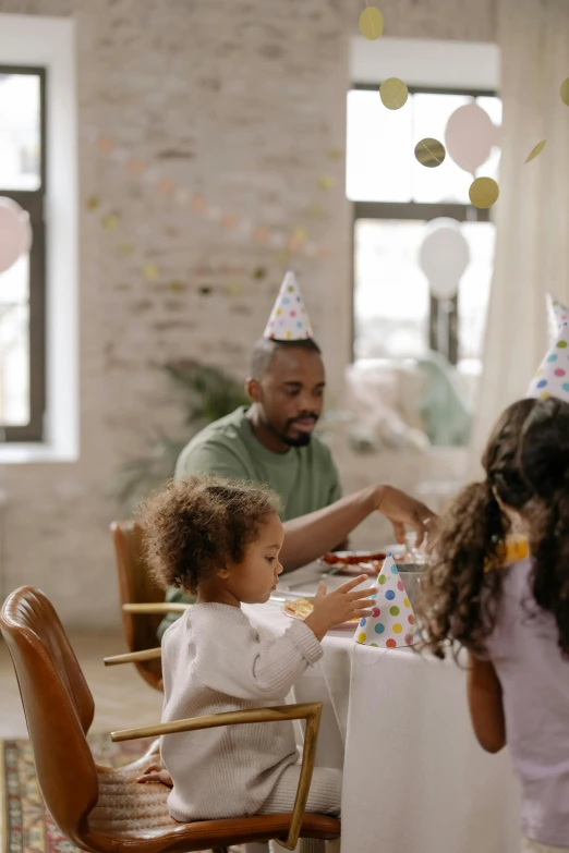 a group of people sitting around a table at a birthday party, pexels contest winner, father with child, profile image, thumbnail, seasonal