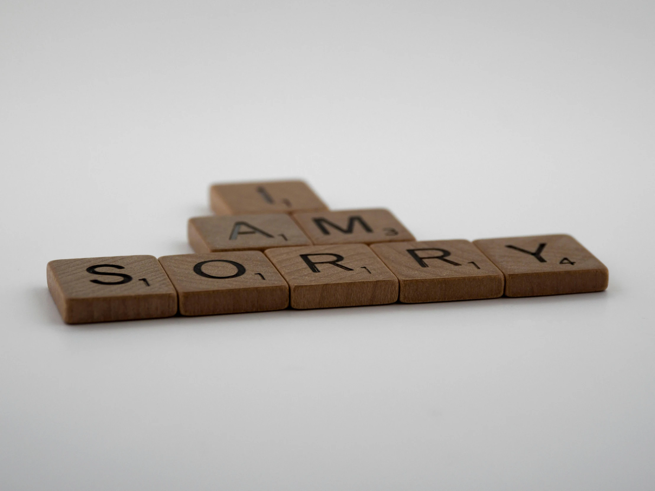 a scrabble that says i am sorry, a picture, pixabay, letterism, cinder blocks, lorem ipsum dolor sit amet, profile image, engraved