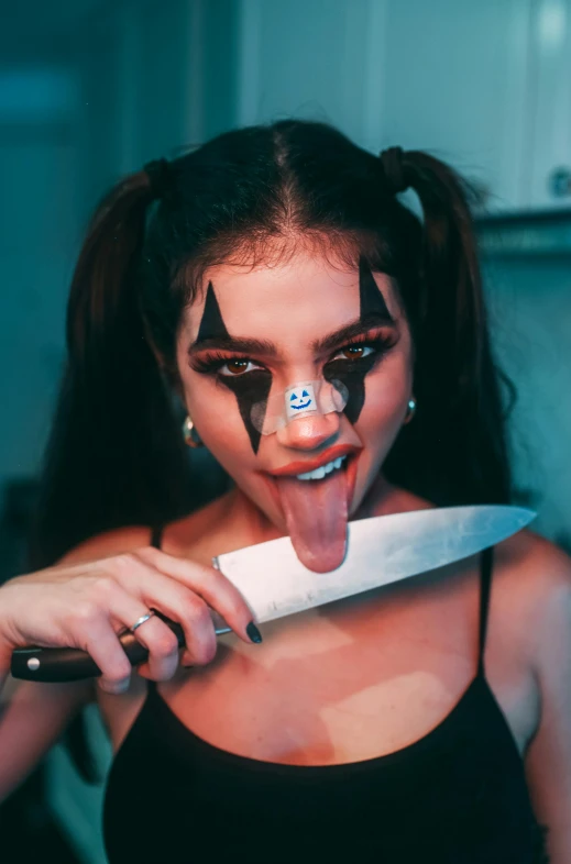 a woman holding a knife in front of her face, an album cover, inspired by Hedi Xandt, trending on pexels, y 2 k cutecore clowncore, :: madison beer, halloween, tongue out